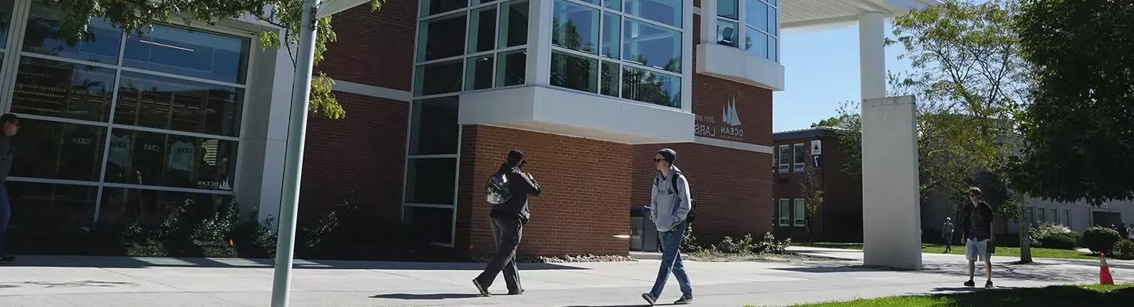 Students walking by a building on campus